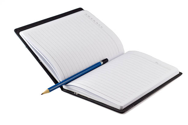 istock Blue pencil on black leather moleskin notebook 503611414