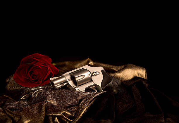 Revolver on Satin with Red Rose stock photo