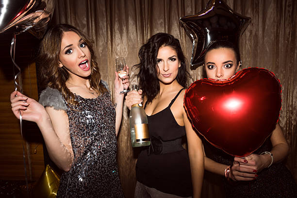 Portrait of a three young woman partying in a nightclub.