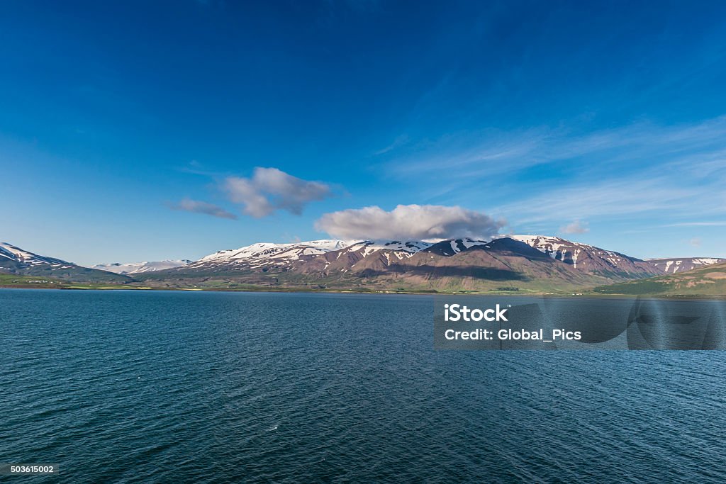 Iceland View of the mountains of the Eyjafjörður on a stunning sunny day in Iceland. Eyjafjörður, (Island Fjord) is the longest fjord in Iceland. It is located in the central north of the country, near the second-most populous region of Iceland. Adventure Stock Photo