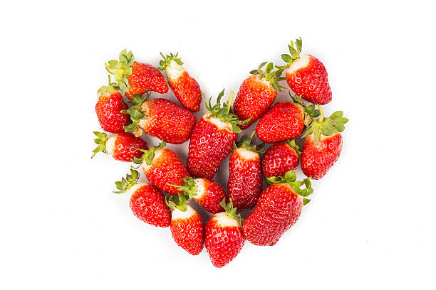 istock Heaps of strawberries form heart shape on white background 503616966