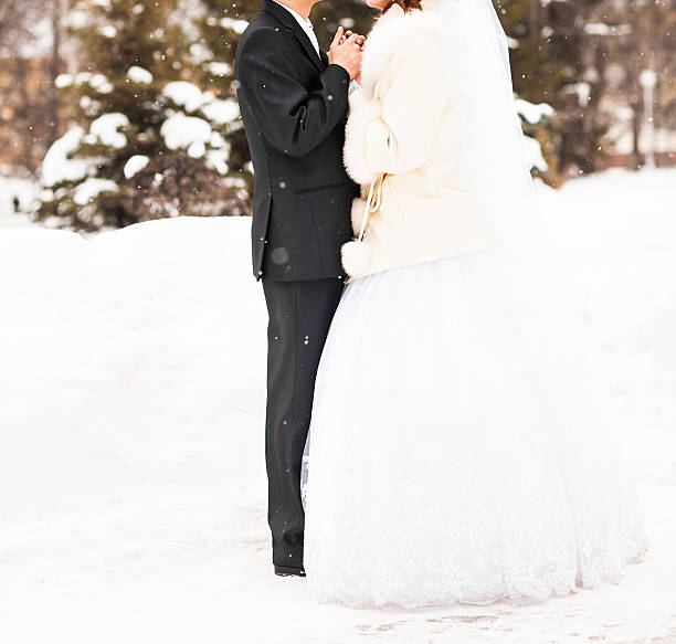 istock bride and groom in the winter park 503620076