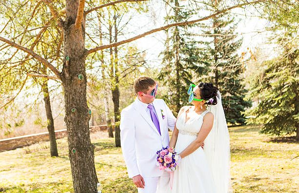 istock young wedding couple  in funny big glasses 503620210