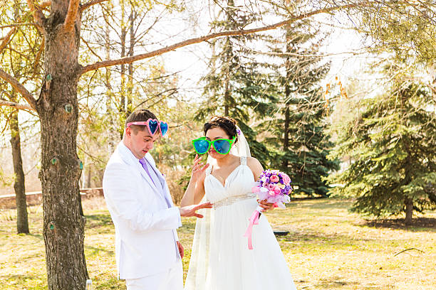 istock young wedding couple  in funny big glasses 503620302
