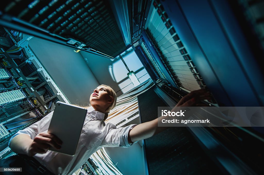 Young engineer businesswoman in server room Young engineer businesswoman in network server room. Russia. Server Room Stock Photo
