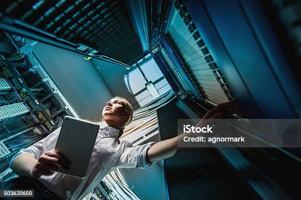 Young Engineer Businesswoman In Server Room Stock Photo - Download Image Now - Server Room, Network Server, Backup