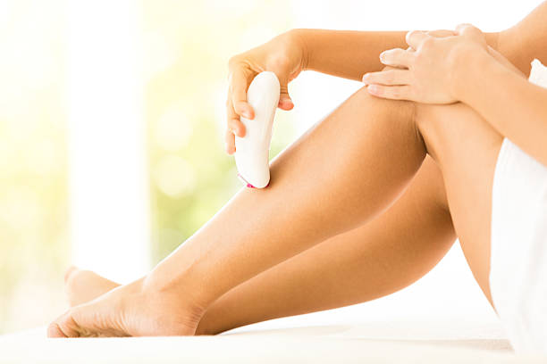 istock Woman epilating her legs 503621727