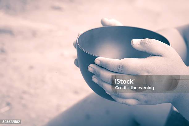 Vintage Color Of A Hungry Children Holding An Empty Bowl Stock Photo - Download Image Now