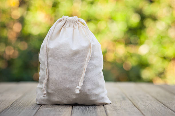 Calico Bag Sitting on Rustic Timber Bench stock photo