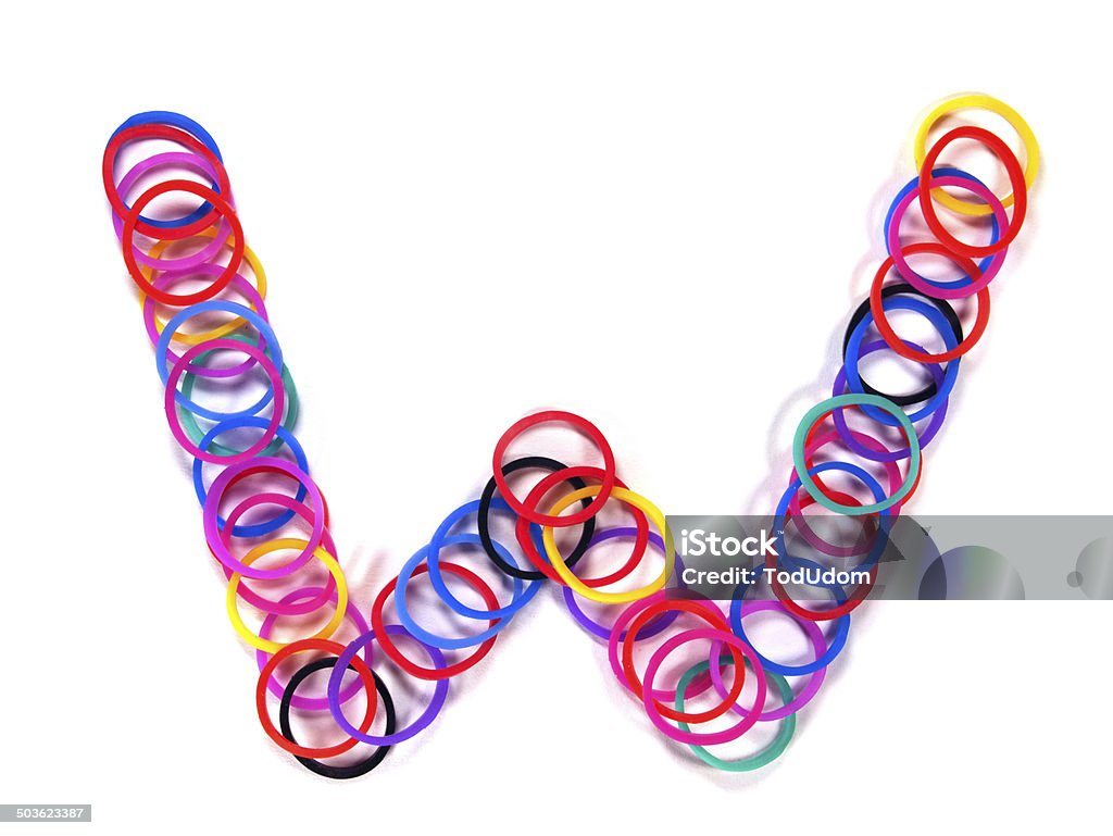 Colorful rubber band character "W". Colorful rubber band character "W" with white isolate, studio shot. Horizontal Stock Photo