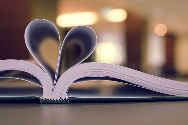 istock heart shape from paper book on table (vintage filter background) 503623496