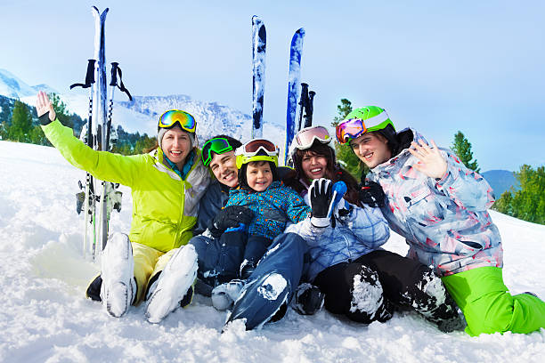 istock Smiling friends after skiing sit on snow together 503624141
