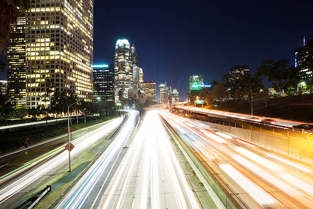 istock traffic on urban road and building at night 503625944