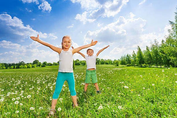 istock Two kids doing outdoor gymnastics on the grass 503627309
