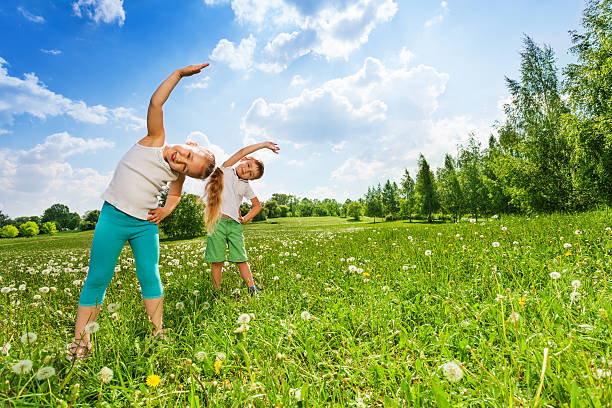 istock Boy and girl doing gymnastics on a meadow 503627315