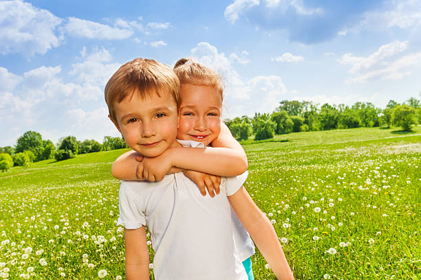 istock Pretty girl embraces boy on a meadow 503627319