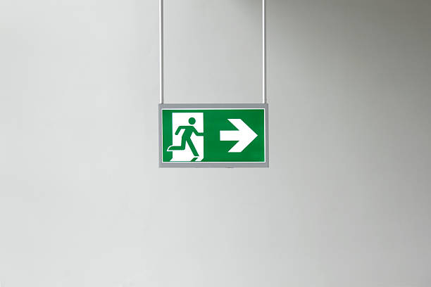 exit sign Closeup of modern illuminated emergency exit sign . exit sign photos stock pictures, royalty-free photos & images