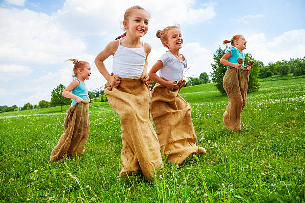 istock Kids having fun with sacks on a meadow 503628427