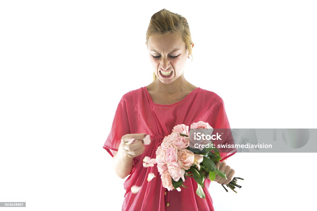 Angry girl destroying roses Angry young woman destroying a bouquet of roses, white background. 20-29 Years Stock Photo