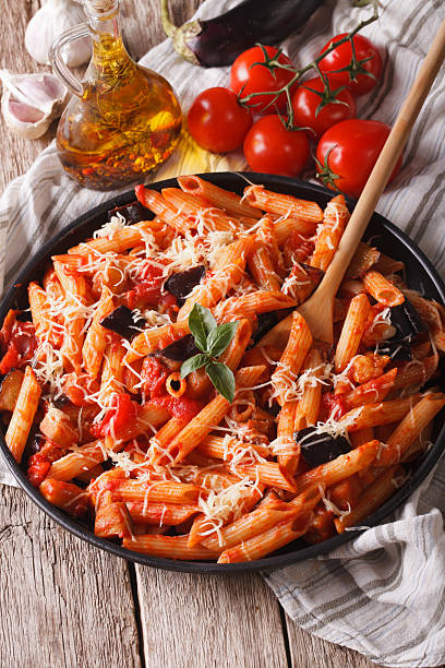 istock Penne with eggplant and tomatoes closeup and ingredients. Vertic 503632976
