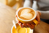 istock lady's hands holding cup with sth heart-shaped 503636498