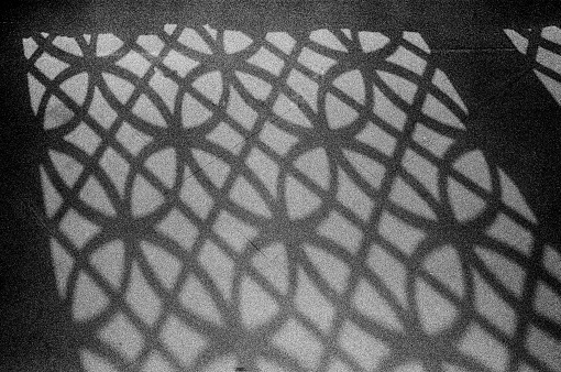 Architectural Abstract - Arabic Styled Mashrabiya design shadow on the concrete floor.
