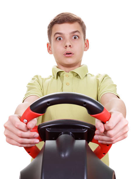 istock Portrait  Boy plays a driving game console, isolated on white 503640270
