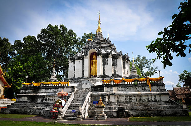 istock Standing Buddha on stupa and Sun shines 503640390