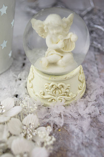 istock Christmas angel statuette on silver background 503644364