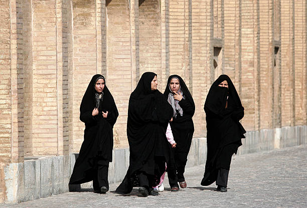 Isfahan,Iran Isfahan,Iran - February 13,2008 : Women in Iran have to wear the burqa.In Iran, women typically dresses in black.Iran women have to wear burqas tourist iranian culture stock pictures, royalty-free photos & images
