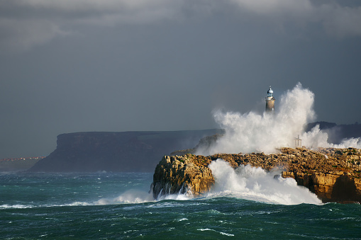 wave splashing in Mouro lighthouse in Santander, Cantabria
