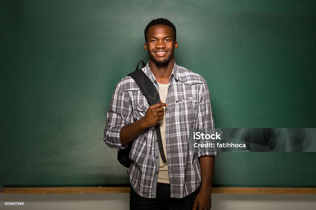 University Student University student posing on blackboard. African-American Ethnicity Stock Photo