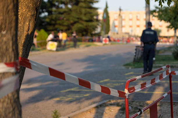 istock Police officer behind red fence at srteet 503662204