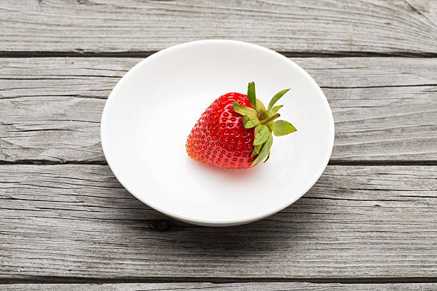 istock Fresh ripe strawberry in a simple white bowl 503662318