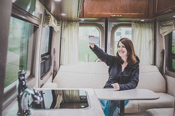 istock Young Woman Looking Mobile phone Inside Motorhome 503662518