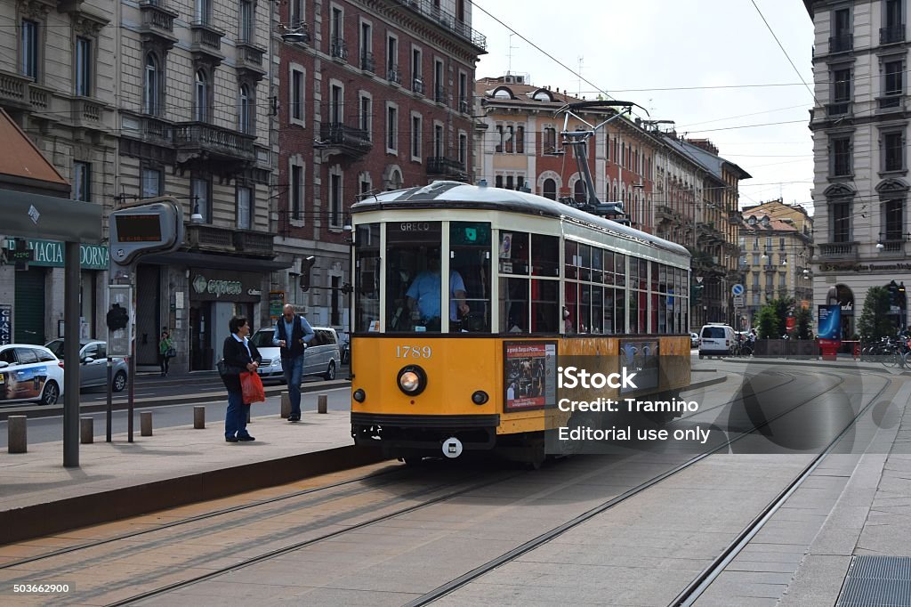 Historical tram in Milan Milan, Italy - May 20th, 2015: Classic yellow tram driving on the street in Milan center. The old trams are the ones of the most attractive objects for tourists in Milan city. Activity Stock Photo