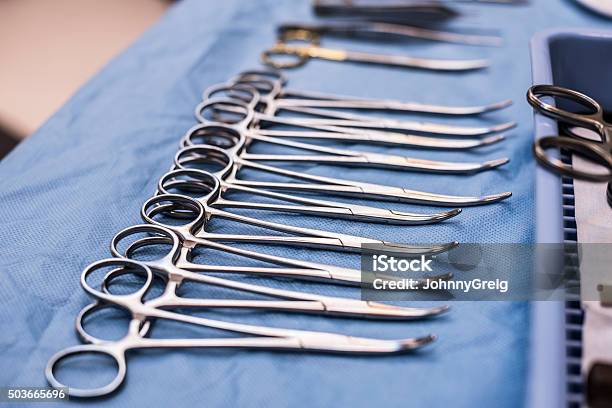 Surgical Scissors Lined Up On Blue Cloth In Operating Theatre Stock Photo - Download Image Now