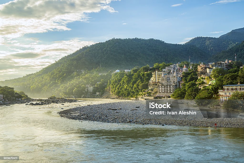 Beautiful bright mountain forest above curved river at sunset Beautiful bright mountain forest above curved river at sunset in Rishikesh, India Bay of Water Stock Photo