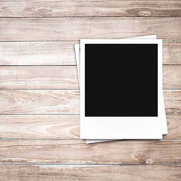 istock blank photo frames on brown wood background 503675043