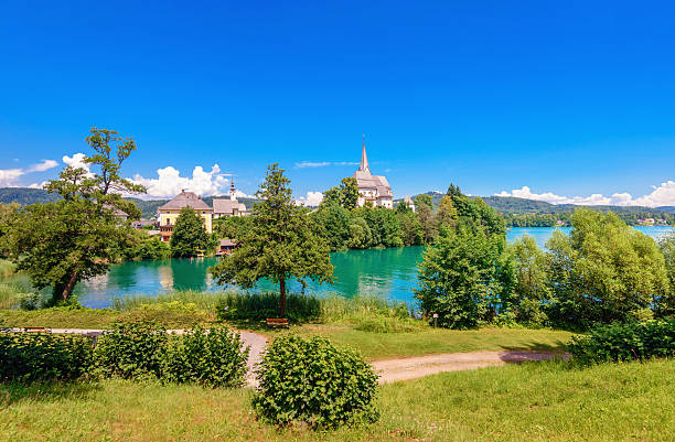 Austrian Summer at Maria Wörth Summer landscape at Maria Wörth at the alps lake Wörthersee, Austria maria woerth stock pictures, royalty-free photos & images