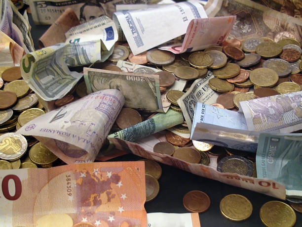 Looking At Different Type Of International Currency Notes And Coins