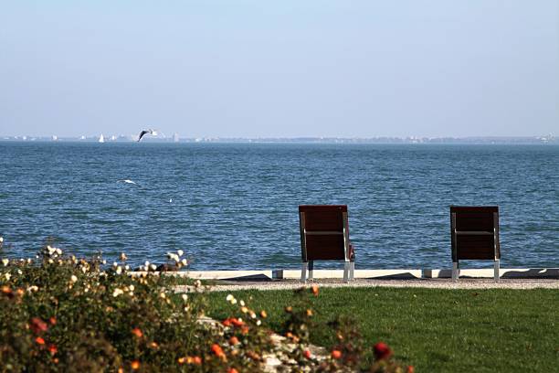 Little boy relaxing on chair by the lake.