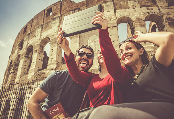 istock Tourists taking a selfie with tablet under the Coliseum 503680916