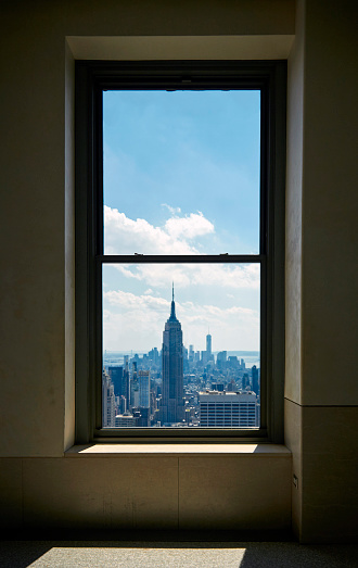 View of Empire State Building in Manhattan New York City skyline buildings from a  window
