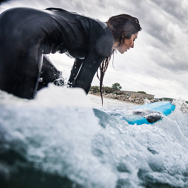 istock Woman surfing in the ocean 503682212