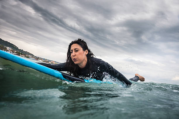 istock Woman surfing in the ocean 503687268