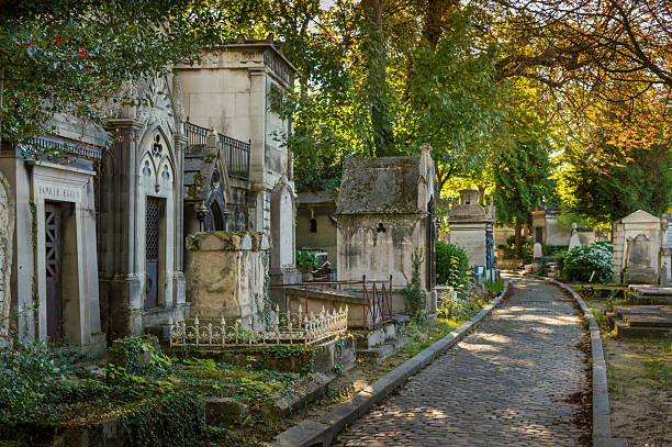 Cemetery of Père Lachaise, Paris, France Tombs along a footpath at the cemetery of Père Lachaise, Paris, France national cemetery stock pictures, royalty-free photos & images