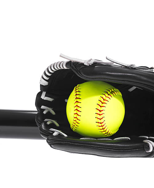 istock Yellow Softball in glove with bat on white background 503688012