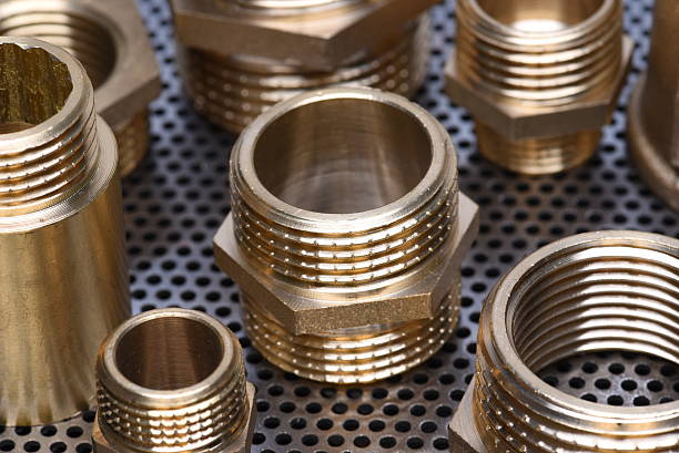 Brass Fittings for Water and Gas Brass Fittings for Water and Gas on Metal Surface electromagnetic induction stock pictures, royalty-free photos & images