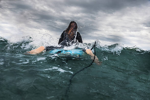 istock Woman surfing in the ocean 503688204